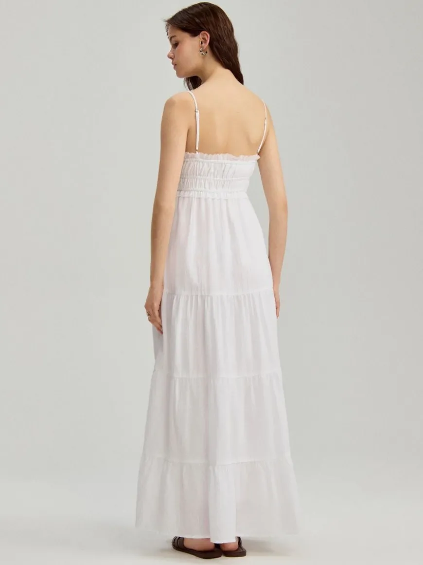 Biała sukienka maxi fit&flare z kieszeniami i falbanami