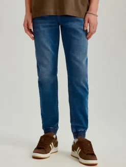 Granatowe jeansowe joggery z przetarciami