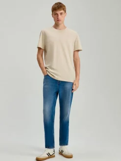 Granatowe jeansy carrot fit z przetarciami