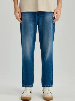 Granatowe jeansy carrot fit z przetarciami