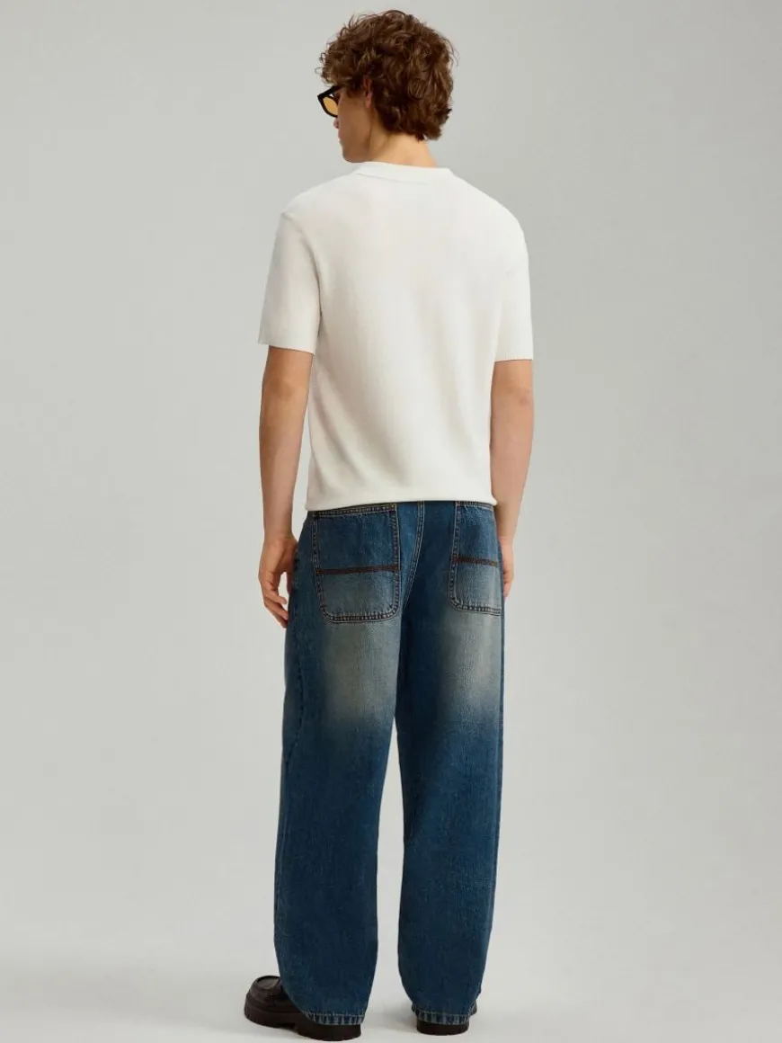 Granatowe jeansy skater fit z przetarciami