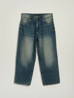Granatowe jeansy skater fit z przetarciami