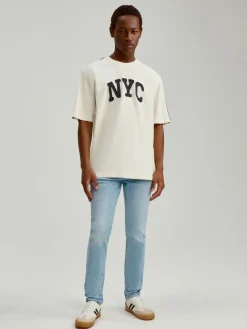 Jasnoniebieskie jeansy slim fit z efektem sprania