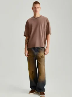 Jeansy super baggy fit w stylu dirty wash z napisami