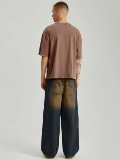 Jeansy super baggy fit w stylu dirty wash z napisami