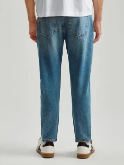 Niebieskie jeansy carrot fit z efektem sprania