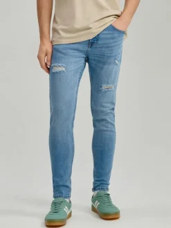 Niebieskie jeansy carrot fit z efektem sprania i przetarciami